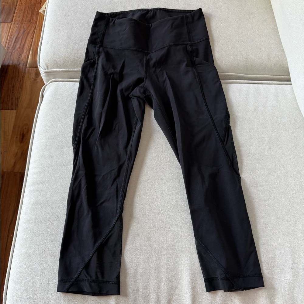 Lululemon black crop leggings with mesh on bottoms, pockets, size 4
